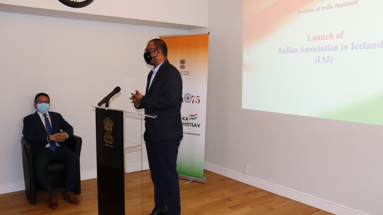 A speaker addresses attendees at an Indian Association in Iceland community event.